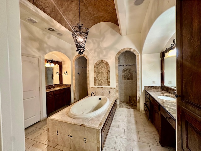 bathroom with vanity, vaulted ceiling, and separate shower and tub