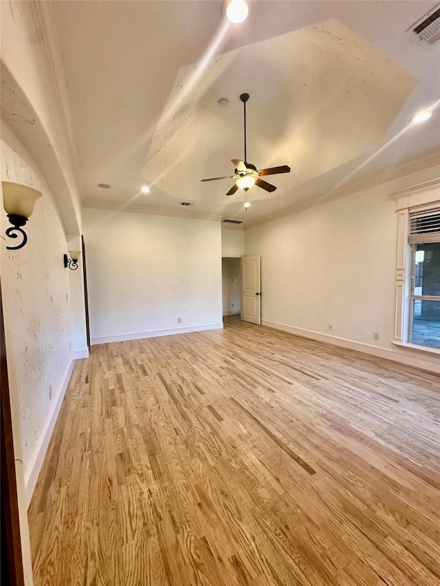 empty room with crown molding, light hardwood / wood-style floors, and ceiling fan