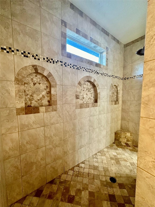 bathroom with a tile shower