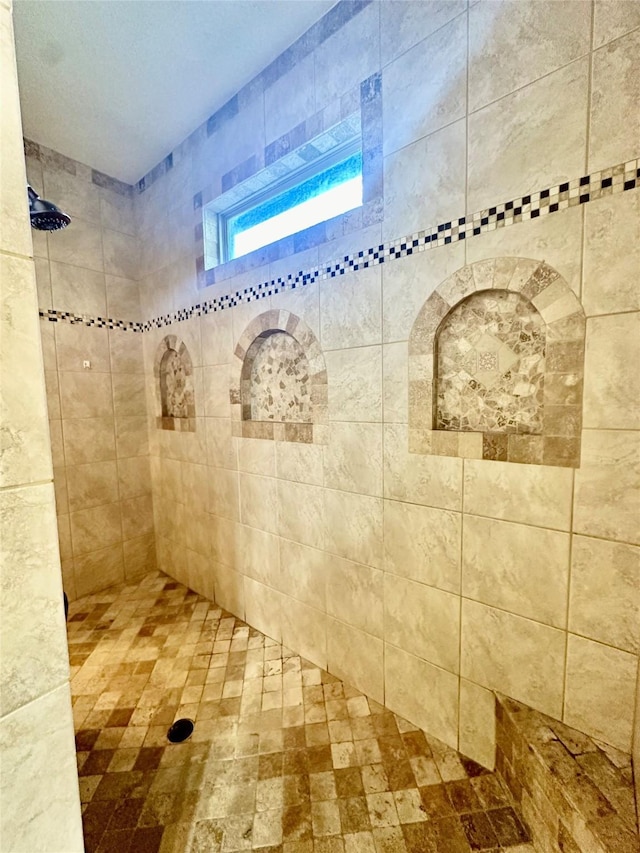 bathroom with tiled shower