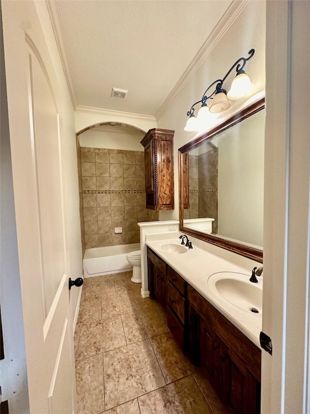 bathroom with vanity, a textured ceiling, ornamental molding, and toilet