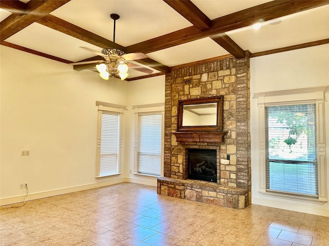 unfurnished living room with beamed ceiling, ceiling fan, coffered ceiling, and a fireplace