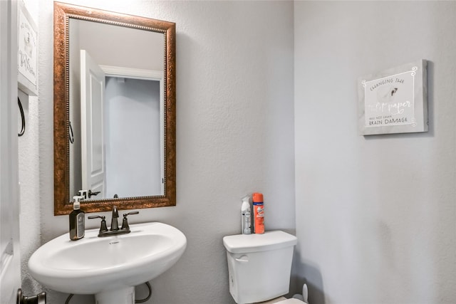 bathroom featuring sink and toilet