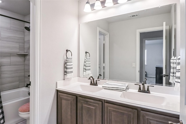 full bathroom with shower / bathtub combination with curtain, vanity, and toilet