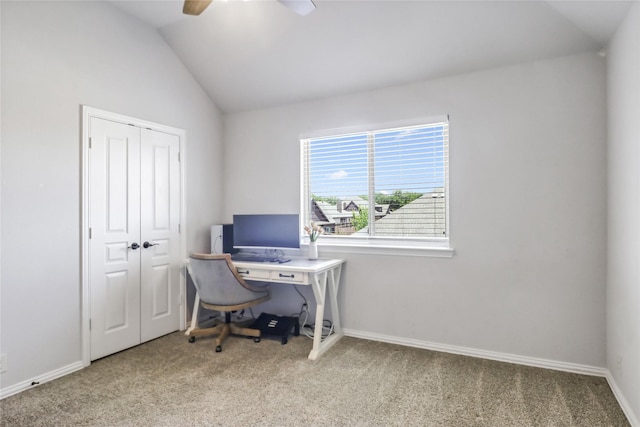 carpeted home office featuring lofted ceiling and ceiling fan