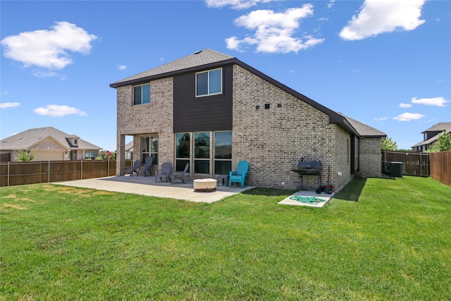 rear view of house with a patio, a yard, and central AC unit