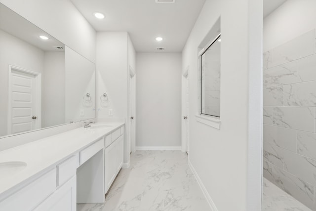 bathroom with walk in shower and vanity