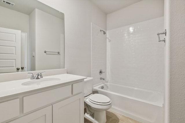 full bathroom with tiled shower / bath, vanity, toilet, and tile patterned floors