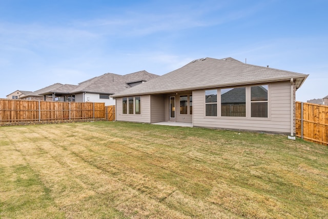 rear view of house featuring a patio area and a lawn