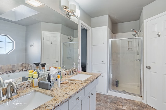 bathroom with vanity, plus walk in shower, and a skylight