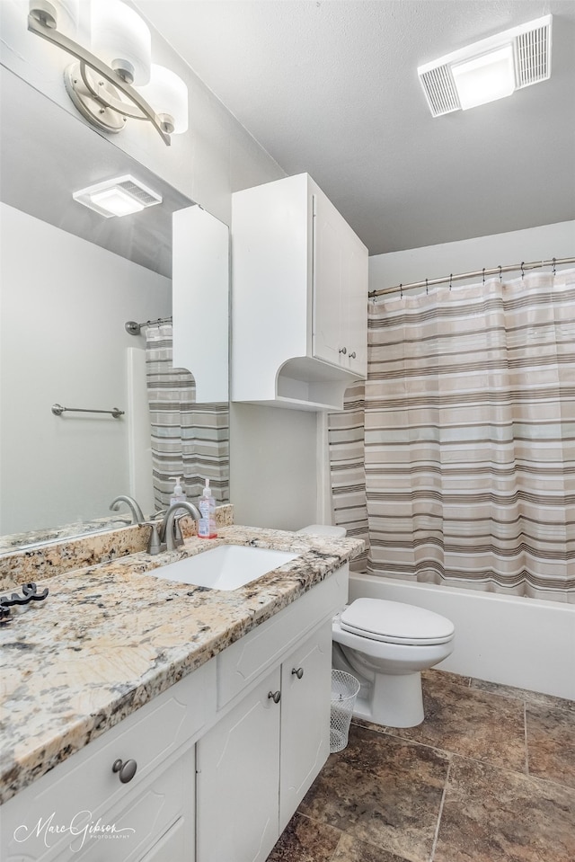 full bathroom with vanity, shower / bath combo, and toilet