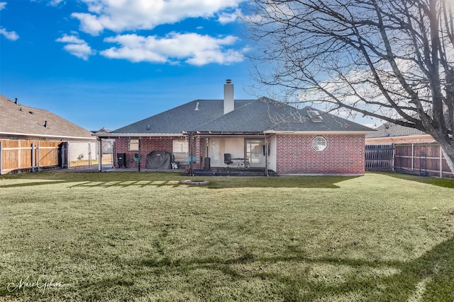 back of property featuring a yard and a patio area