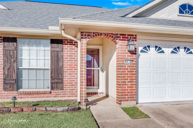 view of exterior entry with a garage