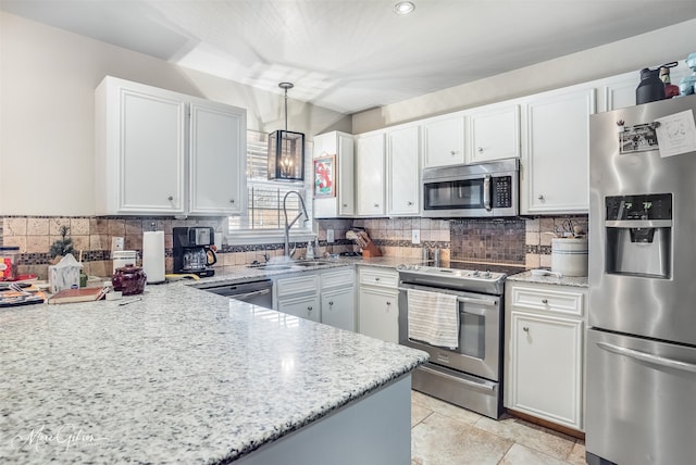 kitchen featuring sink, decorative light fixtures, stainless steel appliances, and white cabinets