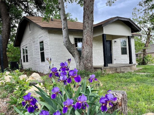 back of house with central AC unit