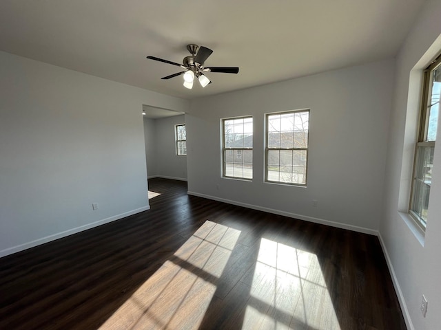 unfurnished room featuring ceiling fan and dark hardwood / wood-style flooring