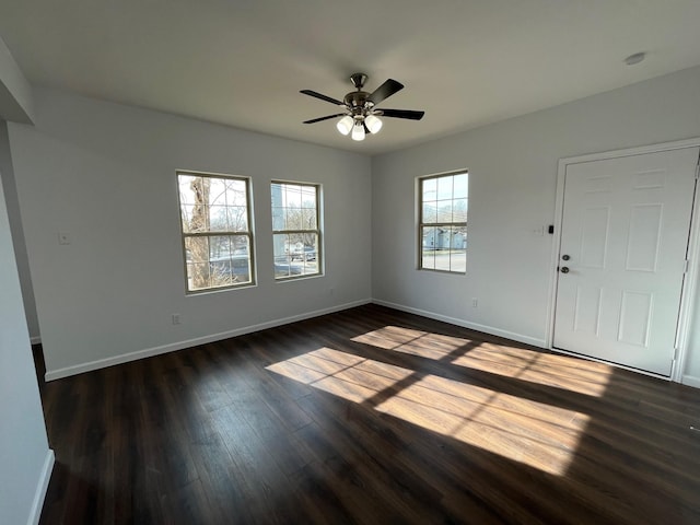 interior space with ceiling fan and dark hardwood / wood-style flooring