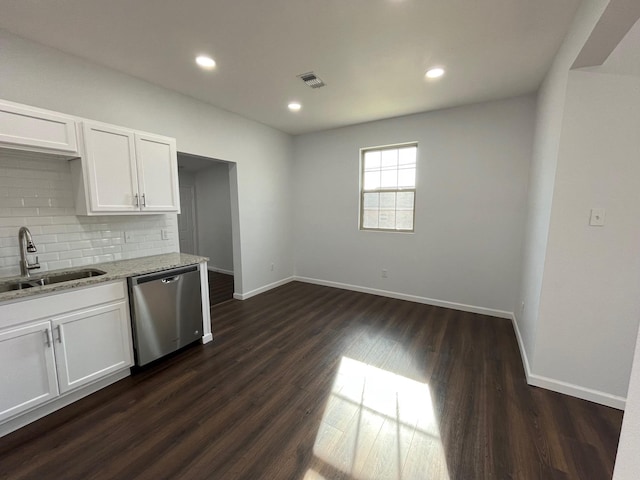 kitchen featuring white cabinetry, dishwasher, sink, and light stone counters