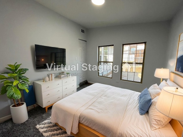 bedroom featuring dark carpet