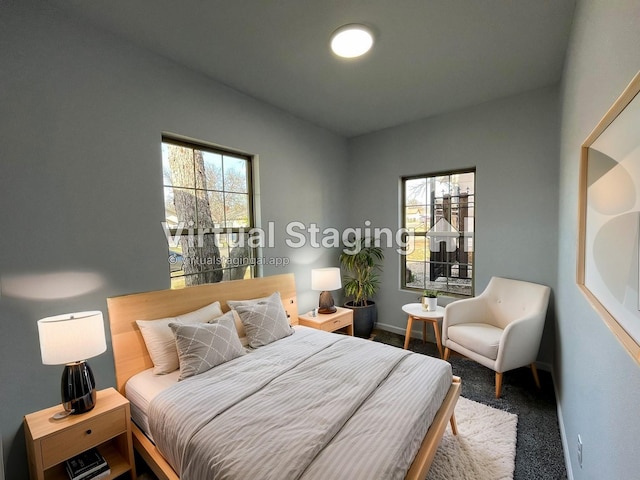 bedroom featuring carpet floors and multiple windows