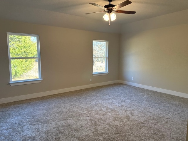 carpeted spare room featuring ceiling fan