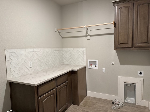 clothes washing area with gas dryer hookup, cabinets, washer hookup, hookup for an electric dryer, and light wood-type flooring