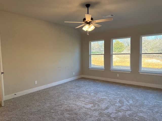 spare room with ceiling fan, lofted ceiling, and carpet