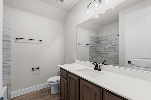 2021 Crystal Palace Blvd, Alvarado, TX 76009 - bathroom with lofted ceiling, toilet, wood finished floors, vanity, and baseboards