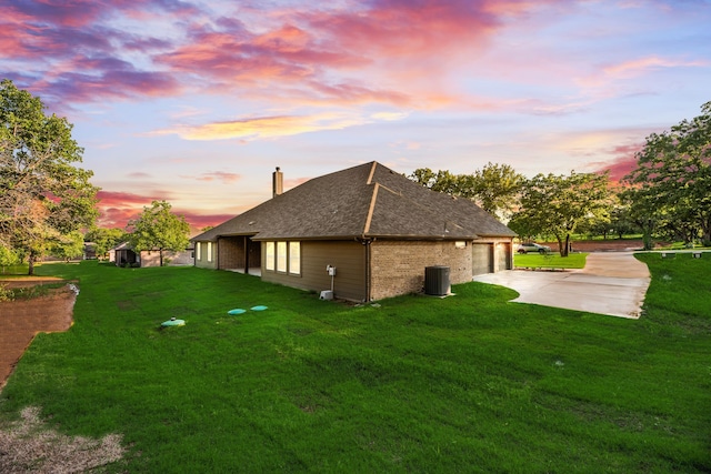 2021 Crystal Palace Blvd, Alvarado, TX 76009 - property exterior at dusk featuring central AC, a yard, a chimney, and concrete driveway