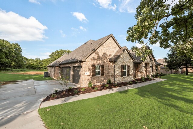 2021 Crystal Palace Blvd, Alvarado, TX 76009 - french country style house featuring concrete driveway, a garage, brick siding, and a front yard