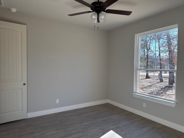 empty room featuring dark hardwood / wood-style floors and ceiling fan