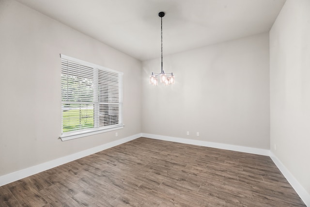 2021 Crystal Palace Blvd, Alvarado, TX 76009 - spare room featuring a chandelier, wood finished floors, and baseboards