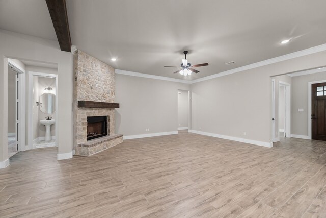 2021 Crystal Palace Blvd, Alvarado, TX 76009 - unfurnished living room with light wood finished floors, a stone fireplace, baseboards, and ceiling fan