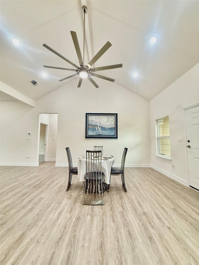 dining area with light wood-type flooring, vaulted ceiling, and ceiling fan