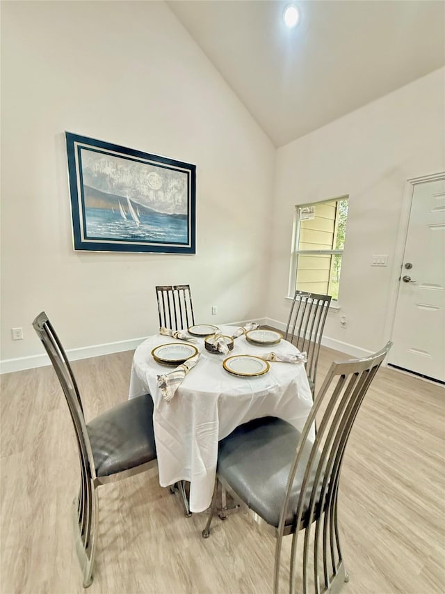 dining space with lofted ceiling and light hardwood / wood-style flooring