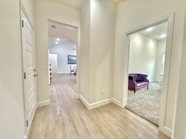 corridor with light hardwood / wood-style floors