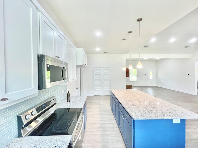 1511 W 13th Ave, Corsicana, TX 75110 - kitchen with stainless steel appliances, blue cabinets, light wood-style floors, backsplash, and light stone countertops
