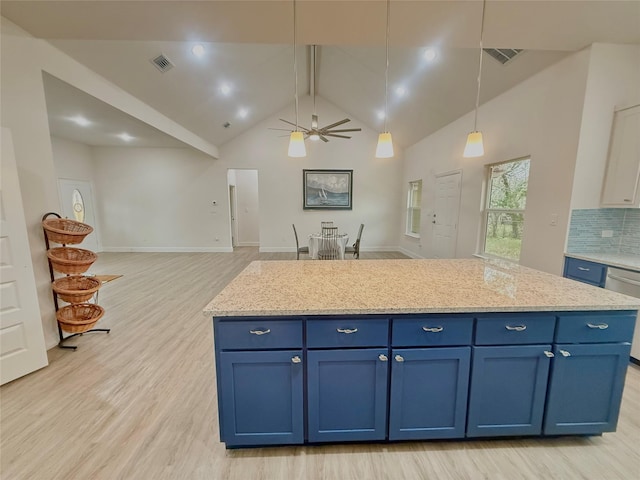 kitchen featuring a kitchen island, blue cabinets, decorative backsplash, hanging light fixtures, and light wood-type flooring