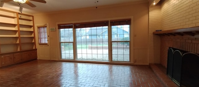 unfurnished living room with crown molding, a fireplace, and ceiling fan