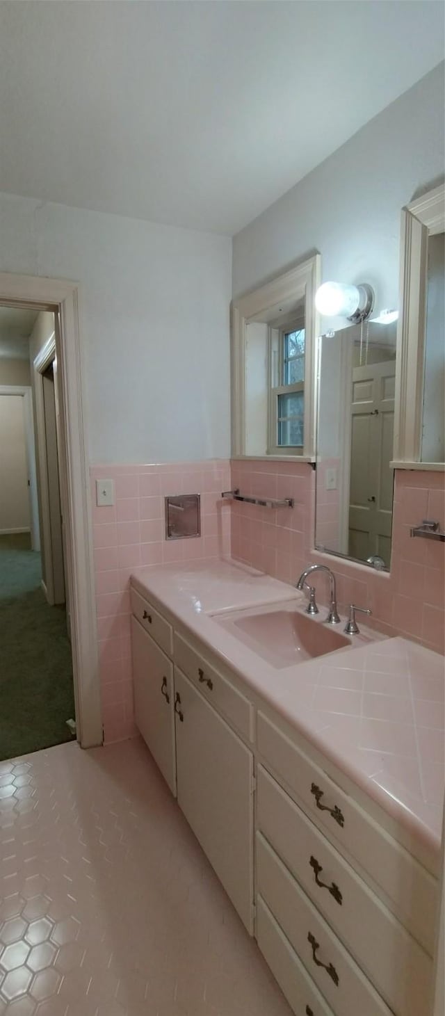 bathroom with vanity and tile walls