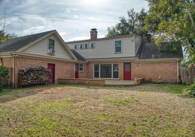 back of property featuring a yard