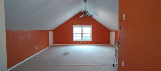 bonus room with vaulted ceiling, ceiling fan, and carpet