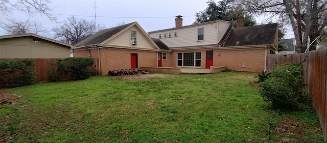 back of property featuring a lawn