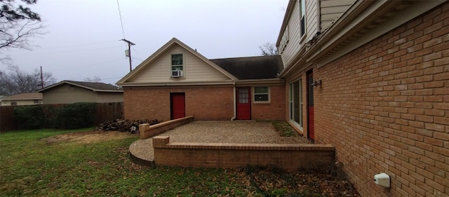 rear view of property featuring a yard and a patio