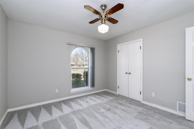 carpeted empty room with ceiling fan