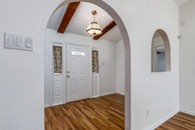 entryway featuring hardwood / wood-style floors and beam ceiling