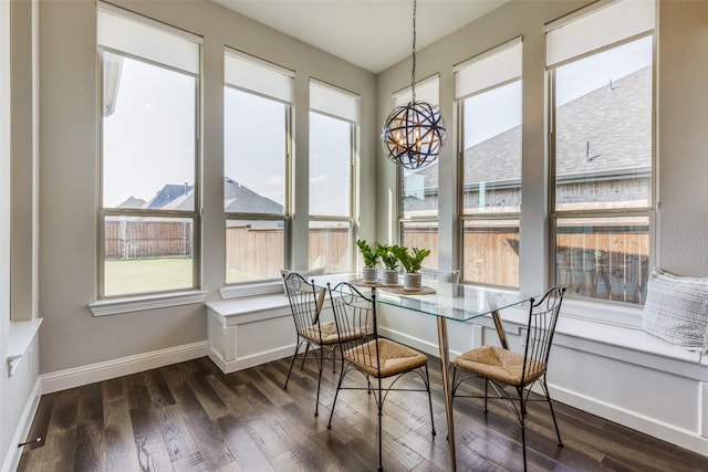 sunroom / solarium with breakfast area and an inviting chandelier