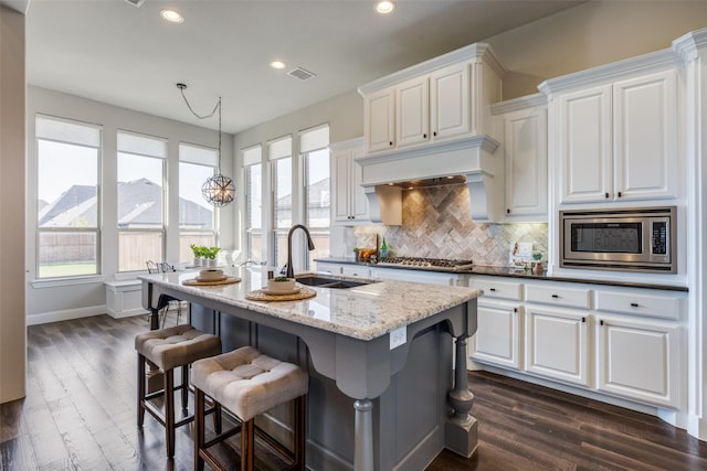 kitchen featuring sink, stainless steel appliances, and white cabinets