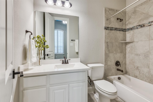 full bathroom featuring vanity, tiled shower / bath combo, and toilet