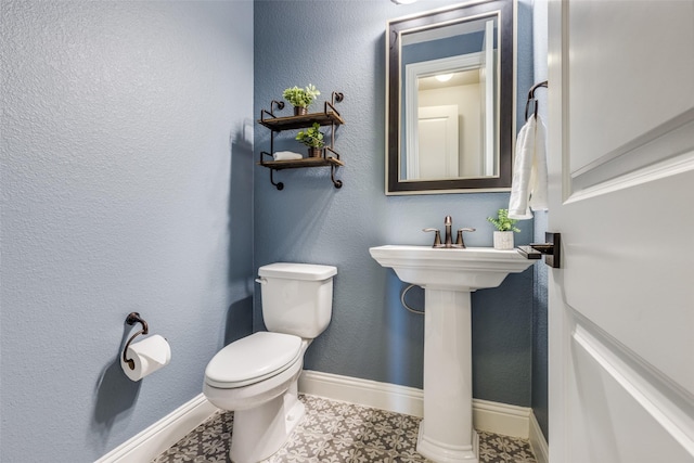 bathroom with tile patterned floors and toilet